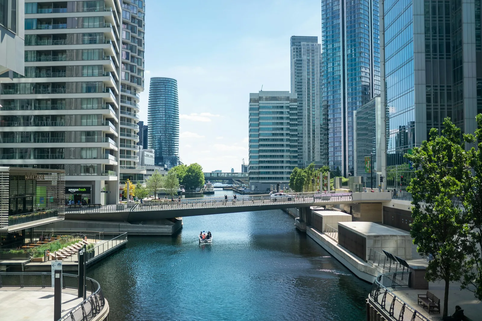 Dock waterway with a footbridge and glass towers in London's Docklands