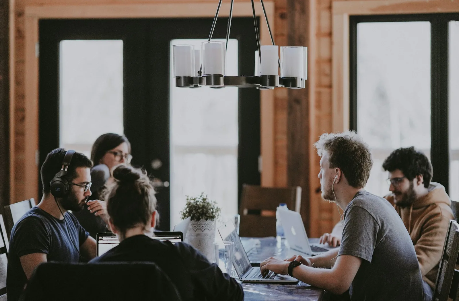 Developers collaborating around a table in a wood-panelled office